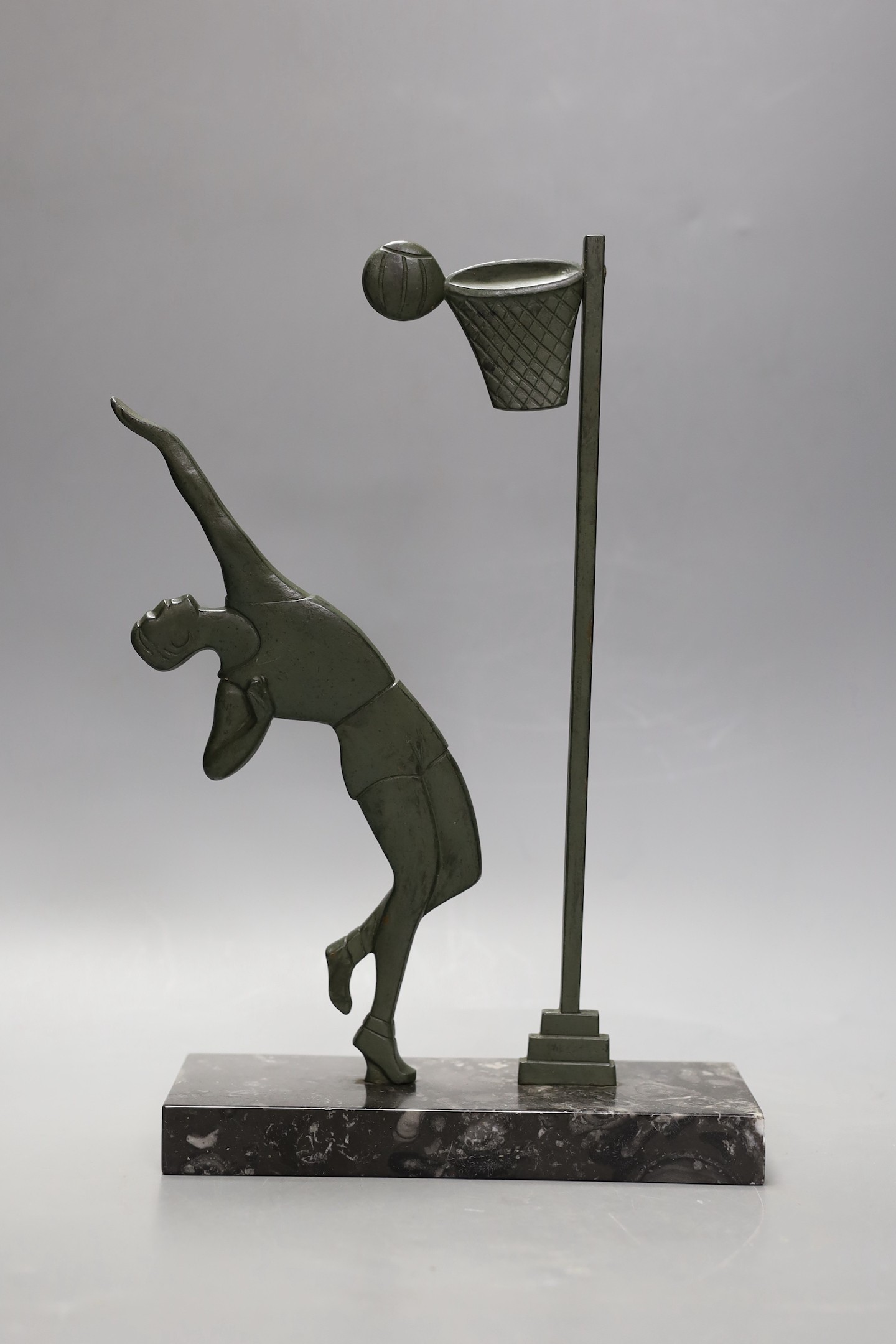 An Art Deco bronze on marble base, of a basket ball player, 32cms high